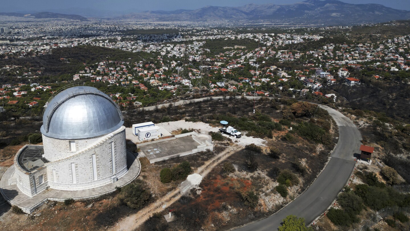 AP PHOTOS: A ferocious blaze scars the land outside Greece’s capital