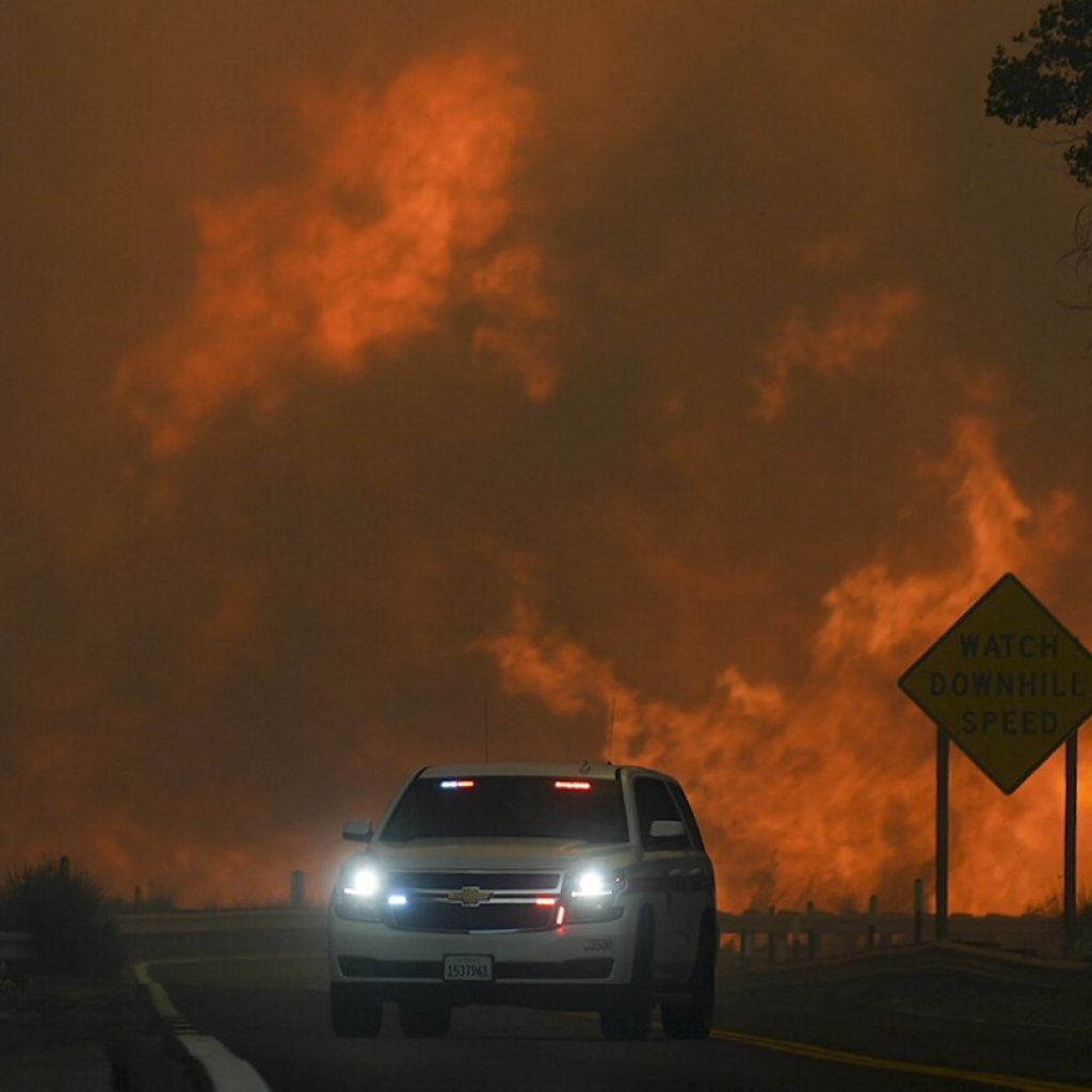 Wildfire east of LA threatens tens of thousands of homes and forces evacuations