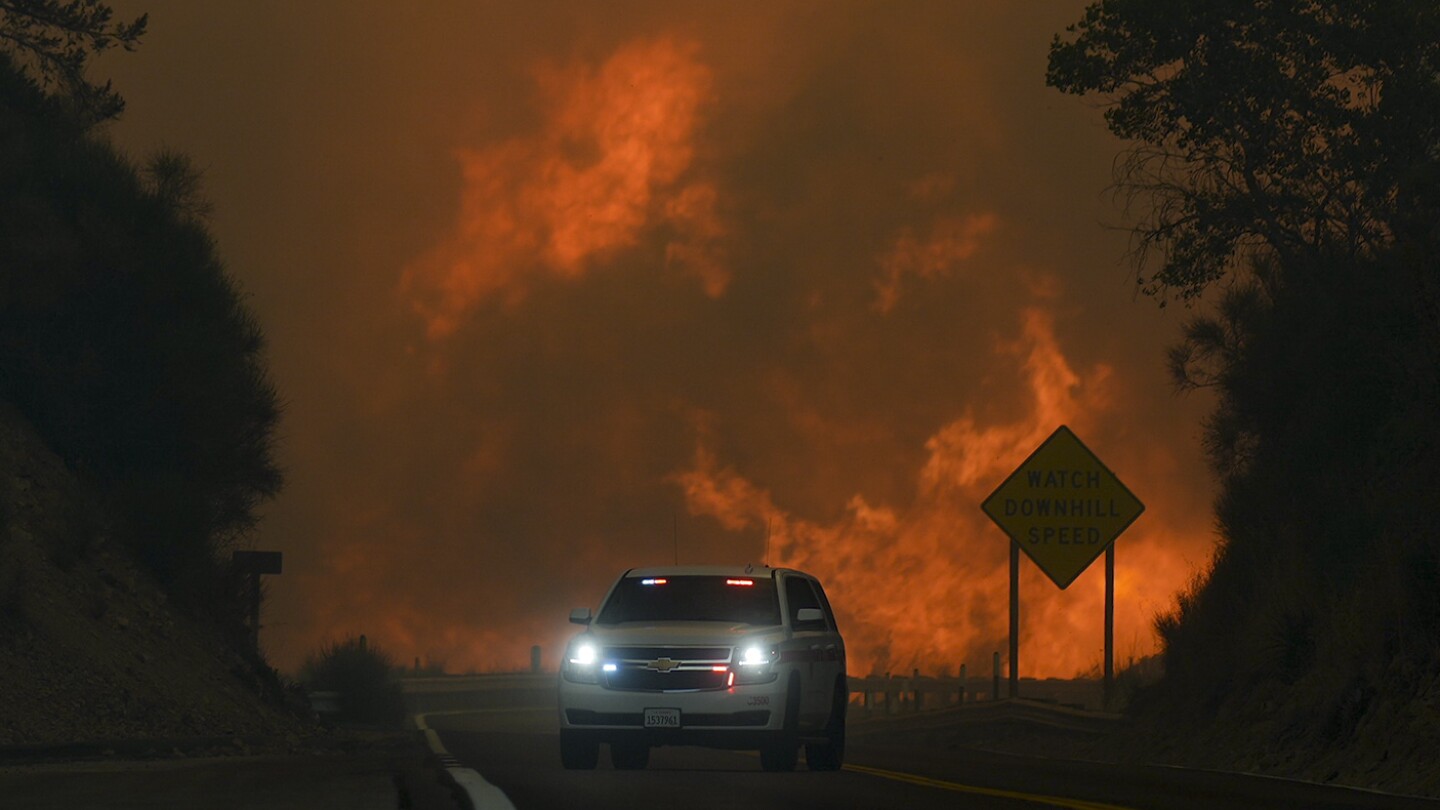 Wildfire east of LA threatens tens of thousands of homes and forces evacuations