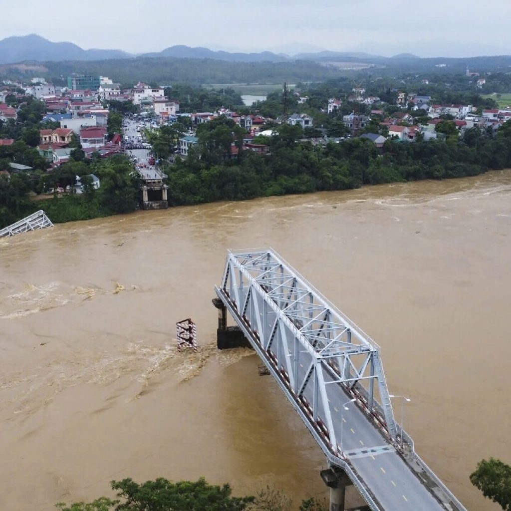 Bridge collapses as more rain falls in Vietnam and storm deaths rise to 21