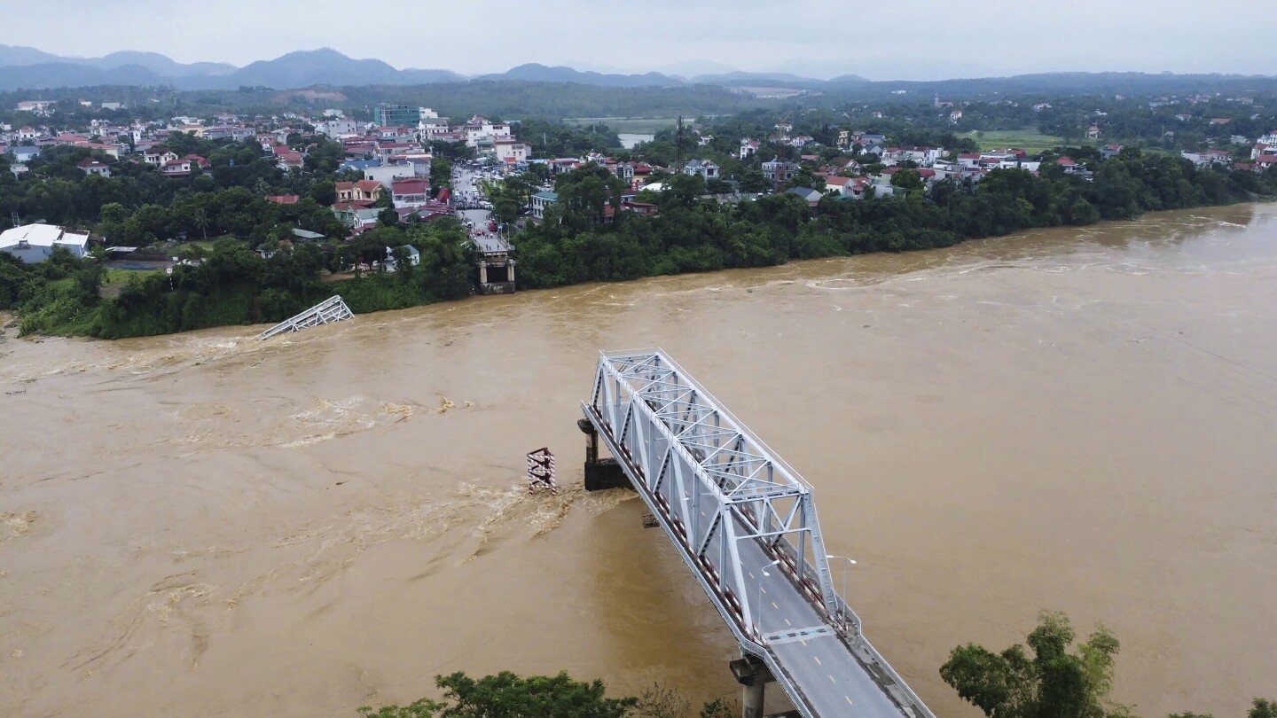 Bridge collapses as more rain falls in Vietnam and storm deaths rise to 21