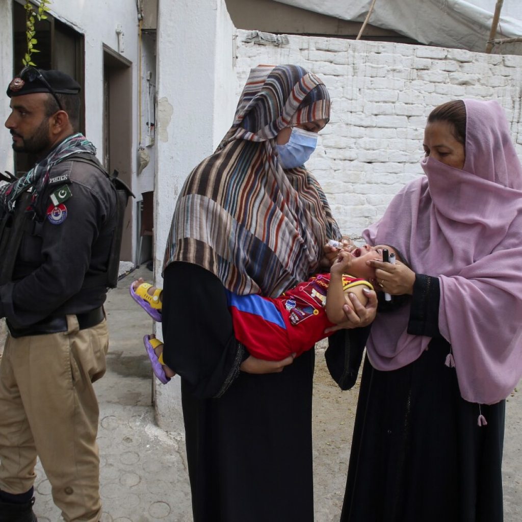 A bomb hits a vehicle guarding an anti-polio drive in Pakistan and wounds 9