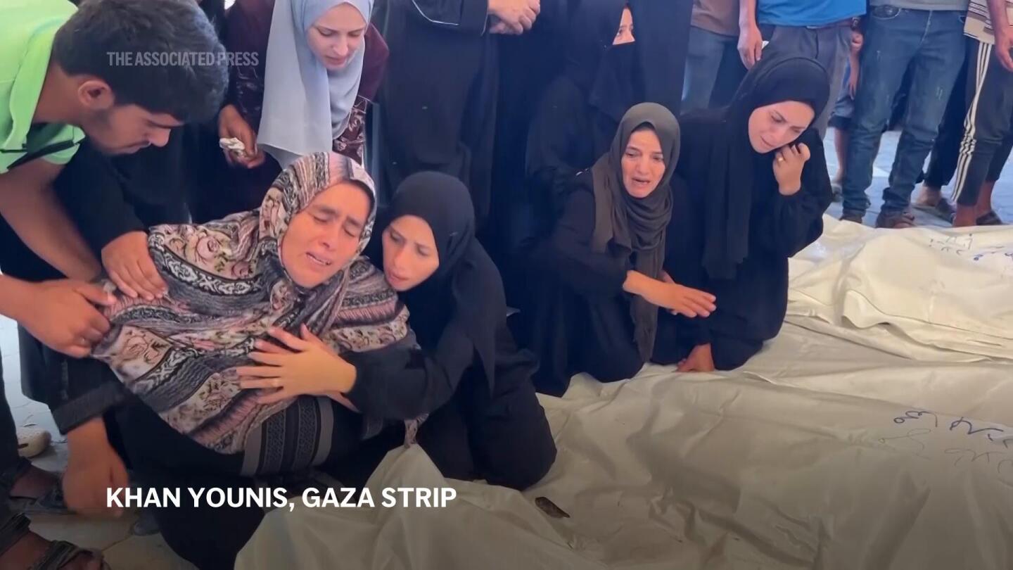 Mourners grieve in morgue after Israeli airstrikes kill at least 20 in Gaza | AP News