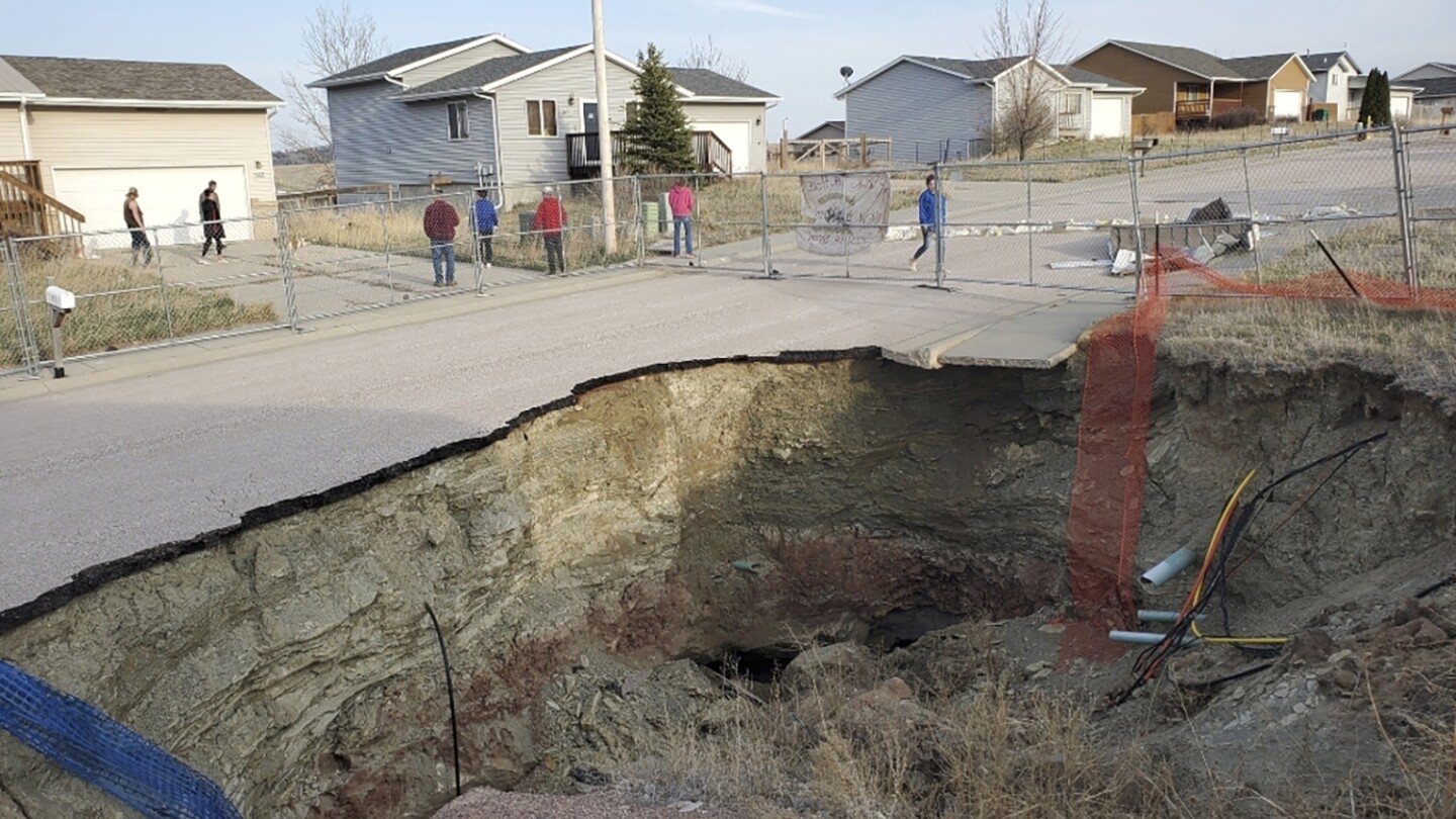 Giant sinkholes in a South Dakota neighborhood make families fear for their safety