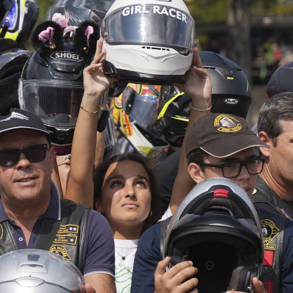 An estimated 180,000 motorcyclists converge at Portuguese shrine to have their helmets blessed.