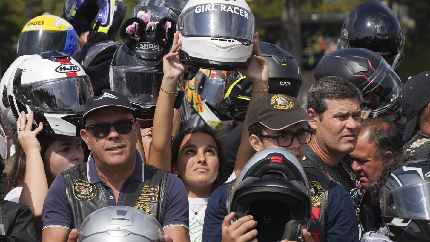 An estimated 180,000 motorcyclists converge at Portuguese shrine to have their helmets blessed.