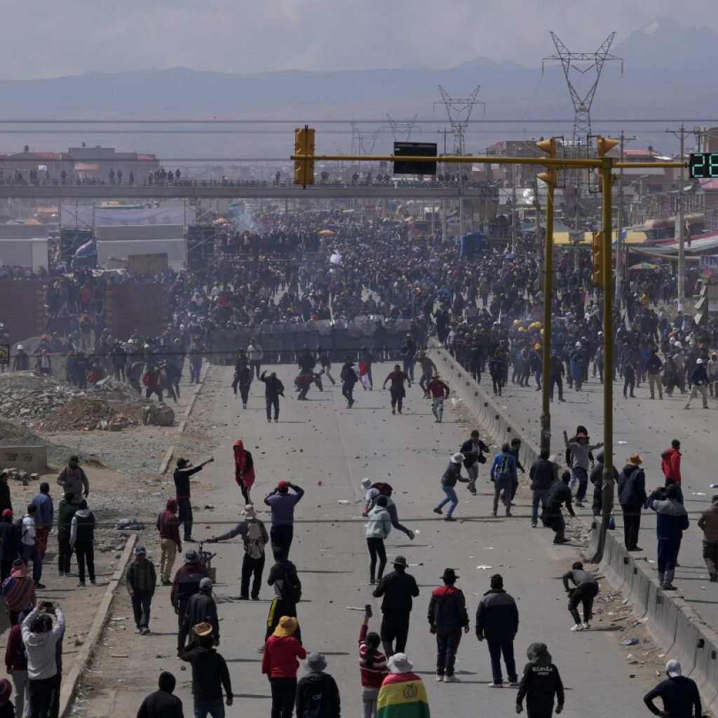 Rival protesters clash in Bolivia as ex-President Evo Morales leads a march to the capital