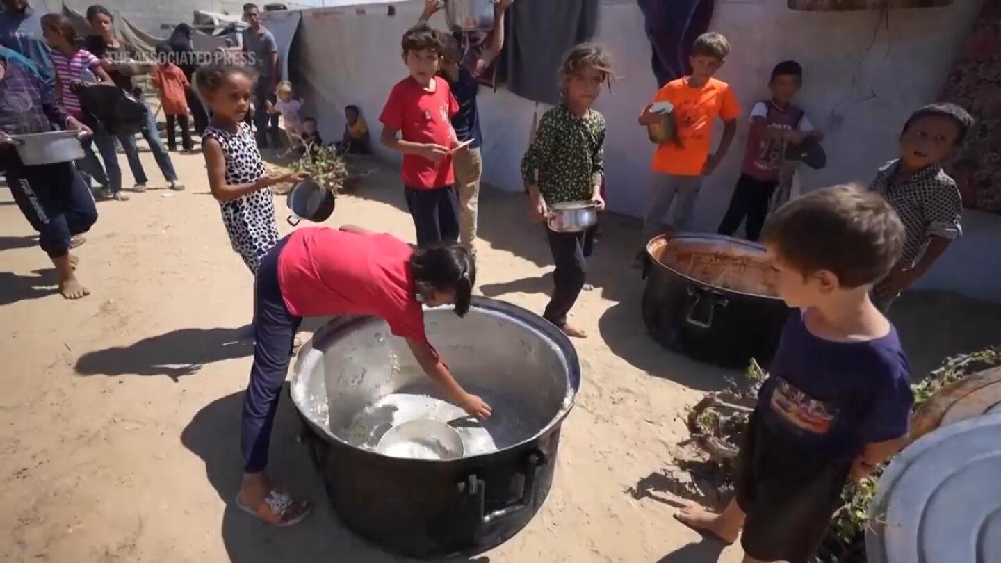 Displaced Palestinians in central Gaza face daily wait for food and queues for water | AP News